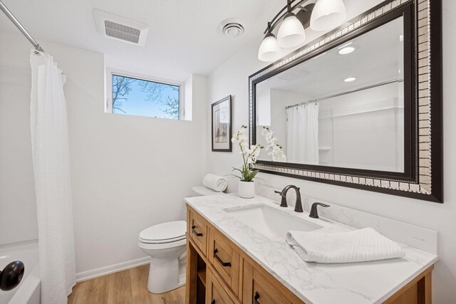 6676 Jason Ave NE, Monticello, MN 55362 - full bath featuring vanity, wood finished floors, and shower / bath combo