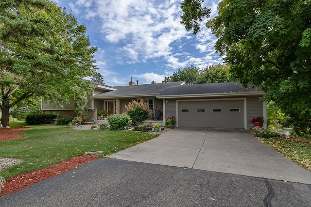 20206 Monks Ave, Mankato, MN 56001 - view of front facade with an attached garage, a front yard, concrete driveway, and a chimney