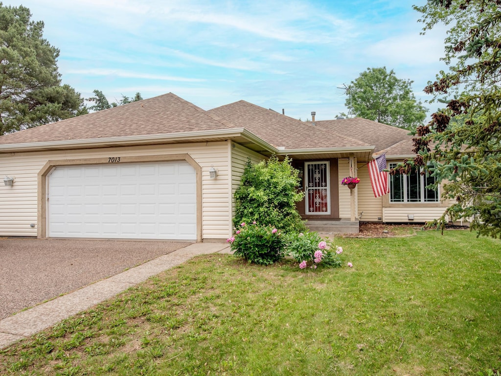 7013 Jensen Ave S, Cottage Grove, MN 55016 - ranch-style house featuring a garage, a front yard, asphalt driveway, and roof with shingles