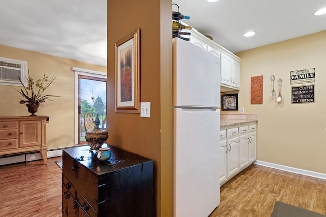 35 Nathan Ln N Unit 104, Plymouth, MN 55441 - kitchen featuring freestanding refrigerator, white cabinets, light wood-type flooring, and recessed lighting
