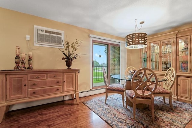 35 Nathan Ln N Unit 104, Plymouth, MN 55441 - dining room featuring an AC wall unit and dark wood-style floors