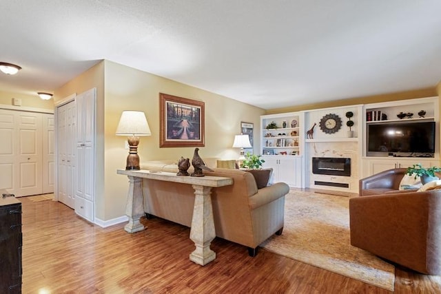 35 Nathan Ln N Unit 104, Plymouth, MN 55441 - living area with light wood finished floors and a glass covered fireplace