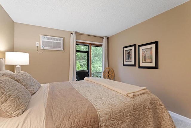 35 Nathan Ln N Unit 104, Plymouth, MN 55441 - bedroom featuring carpet floors, an AC wall unit, access to outside, and a textured ceiling