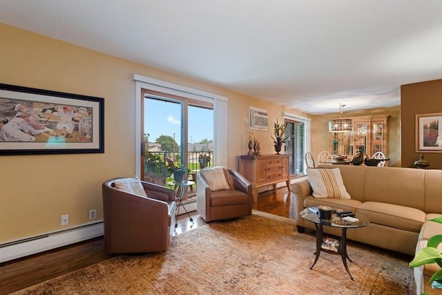 35 Nathan Ln N Unit 104, Plymouth, MN 55441 - living room with wood finished floors, a baseboard heating unit, a chandelier, and a wall unit AC