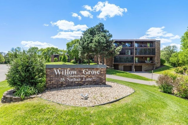 35 Nathan Ln N Unit 104, Plymouth, MN 55441 - community / neighborhood sign with driveway, an attached garage, and a yard