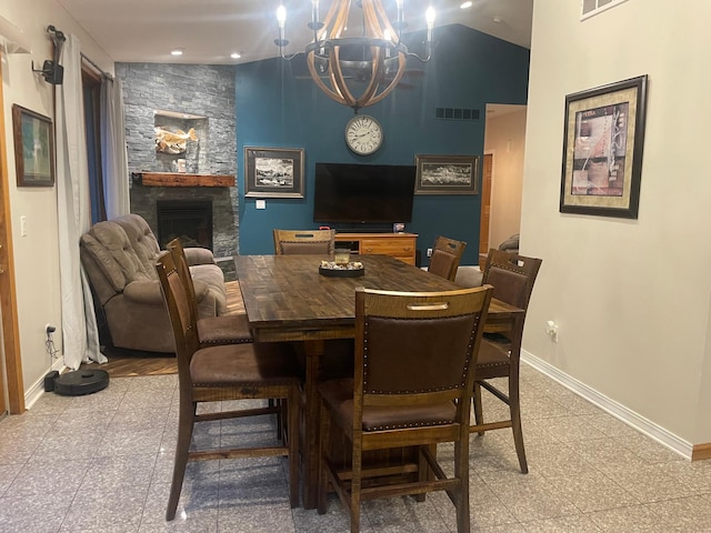 26780 Packard St NE, Athens Twp, MN 55040 - dining area featuring granite tiled floors, a chandelier, a fireplace, recessed lighting, and lofted ceiling