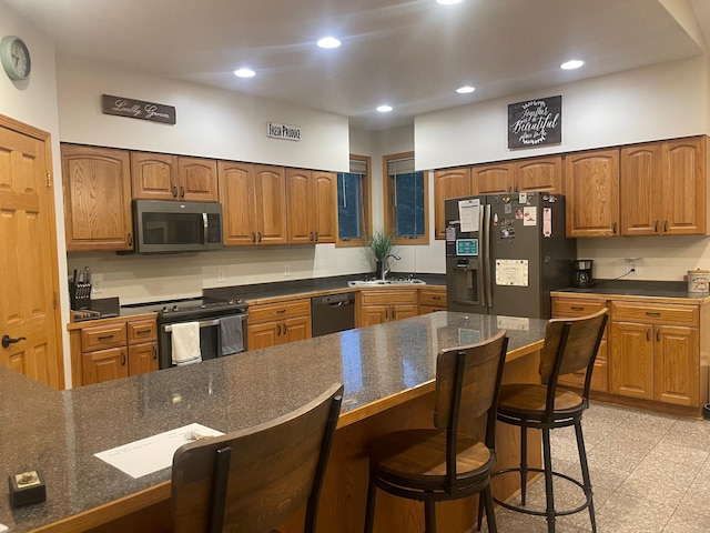 26780 Packard St NE, Athens Twp, MN 55040 - kitchen with stainless steel appliances, a breakfast bar area, recessed lighting, and brown cabinets
