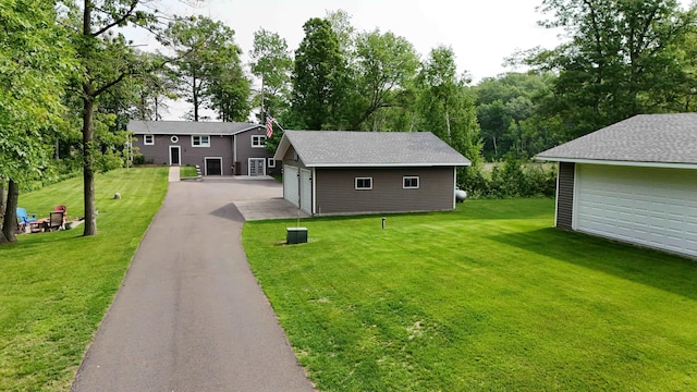 695 Pine Lake Ln, Bone Lake Twp, WI 54837 - view of front facade with an outbuilding, a front yard, and a garage