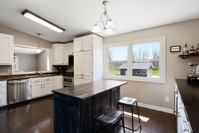 695 Pine Lake Ln, Bone Lake Twp, WI 54837 - kitchen featuring stainless steel appliances, vaulted ceiling, dark wood-style flooring, white cabinets, and a breakfast bar area