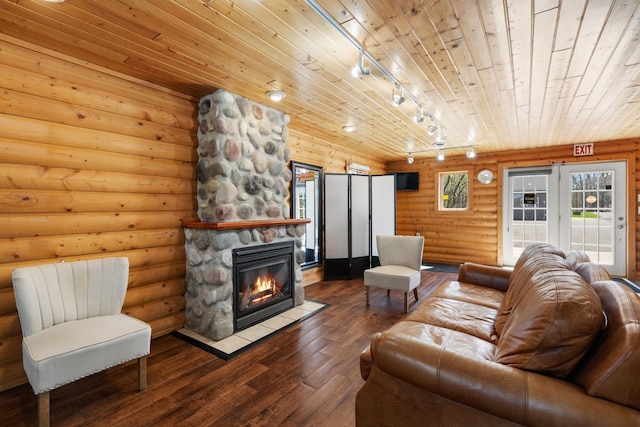 695 Pine Lake Ln, Bone Lake Twp, WI 54837 - living room with rail lighting, dark wood-type flooring, a fireplace, wooden ceiling, and log walls