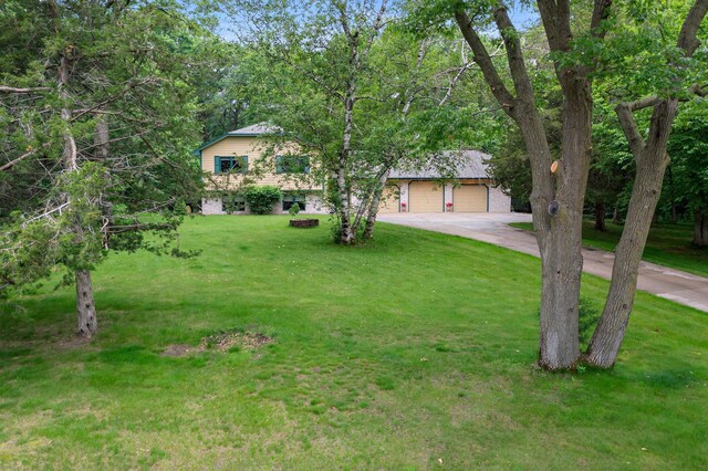 9855 Kadler Ave NE, Otsego, MN 55362 - obstructed view of property featuring driveway, a front yard, and an attached garage