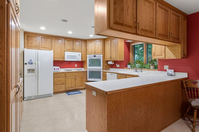 9855 Kadler Ave NE, Otsego, MN 55362 - kitchen with white appliances, a peninsula, light countertops, light flooring, and recessed lighting