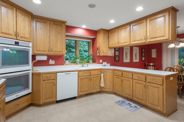 9855 Kadler Ave NE, Otsego, MN 55362 - kitchen with white appliances, a peninsula, light countertops, recessed lighting, and a chandelier