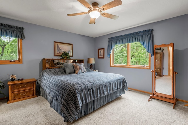 9855 Kadler Ave NE, Otsego, MN 55362 - bedroom with multiple windows, carpet floors, and a ceiling fan