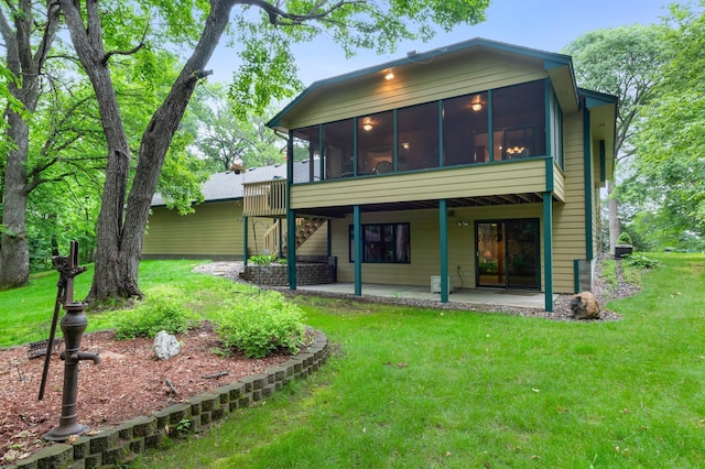 9855 Kadler Ave NE, Otsego, MN 55362 - rear view of property with a patio area, a yard, and a sunroom
