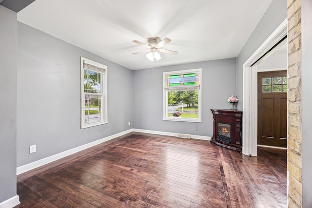 13805 Central Ave, Becker, MN 55308 - unfurnished living room featuring a ceiling fan, wood-type flooring, and a glass covered fireplace