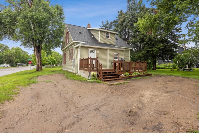 13805 Central Ave, Becker, MN 55308 - view of front of home with a shingled roof, a wooden deck, and a chimney