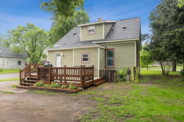 13805 Central Ave, Becker, MN 55308 - back of house featuring a shingled roof, a deck, a chimney, and a yard