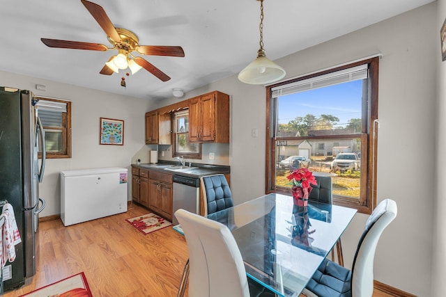 5215 Washburn Ave N, Minneapolis, MN 55430 - dining area featuring light wood finished floors, ceiling fan, and healthy amount of natural light