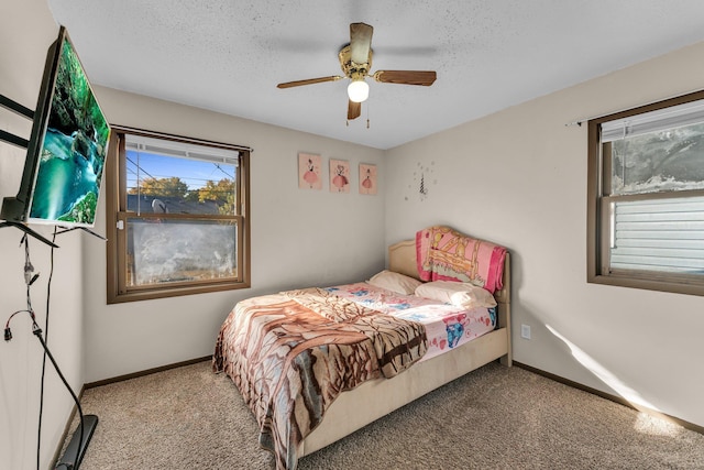 5215 Washburn Ave N, Minneapolis, MN 55430 - bedroom featuring multiple windows, carpet floors, ceiling fan, and a textured ceiling