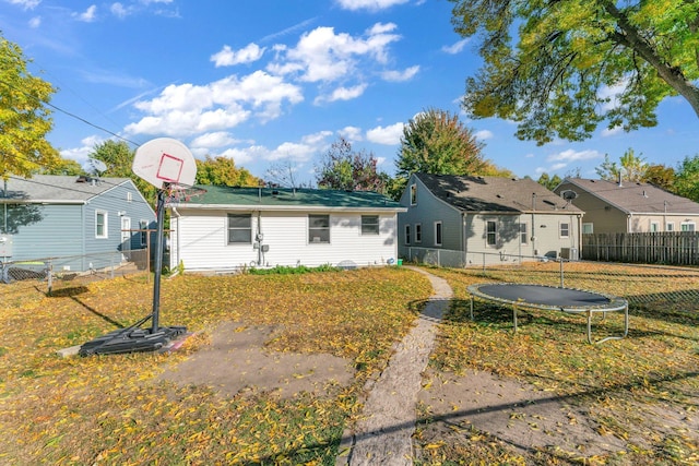 5215 Washburn Ave N, Minneapolis, MN 55430 - rear view of property with a trampoline and a fenced backyard