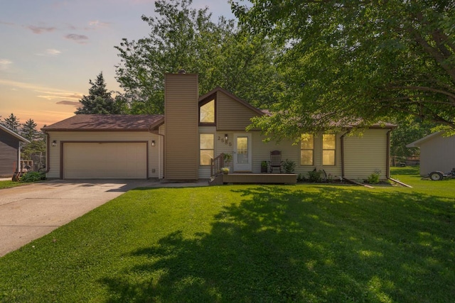 2585 3rd Ave NE, Owatonna, MN 55060 - mid-century home featuring a garage, a chimney, driveway, and a yard