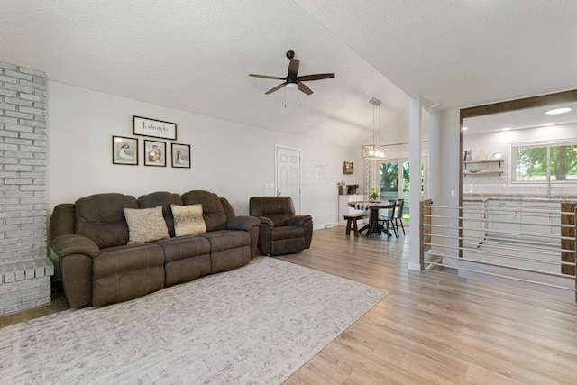 2585 3rd Ave NE, Owatonna, MN 55060 - living area with a ceiling fan, light wood-type flooring, vaulted ceiling, and a textured ceiling