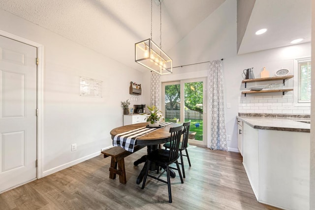 2585 3rd Ave NE, Owatonna, MN 55060 - dining room featuring wood finished floors, lofted ceiling, and a chandelier