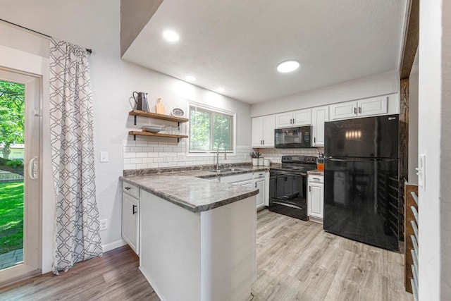 2585 3rd Ave NE, Owatonna, MN 55060 - kitchen with black appliances, plenty of natural light, a peninsula, light wood-type flooring, and recessed lighting