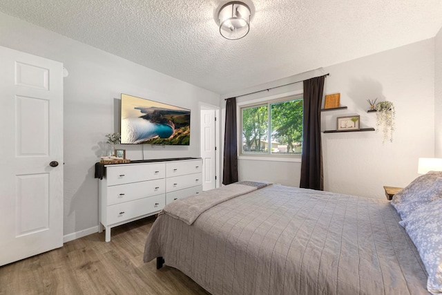 2585 3rd Ave NE, Owatonna, MN 55060 - bedroom with wood finished floors and a textured ceiling