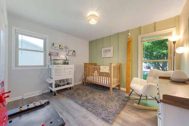 2585 3rd Ave NE, Owatonna, MN 55060 - bedroom featuring wood finished floors and a nursery area