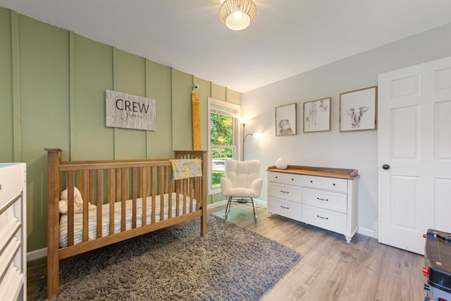 2585 3rd Ave NE, Owatonna, MN 55060 - bedroom featuring wood finished floors and a nursery area