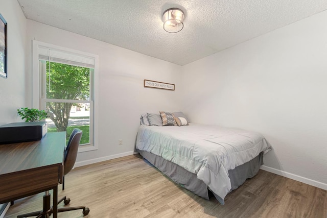 2585 3rd Ave NE, Owatonna, MN 55060 - bedroom with light wood finished floors, a textured ceiling, and a desk