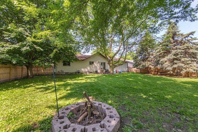 2585 3rd Ave NE, Owatonna, MN 55060 - fenced backyard with an outdoor fire pit