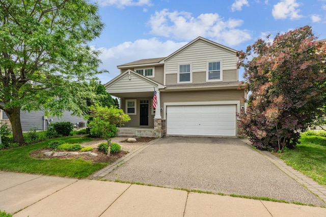 6773 Urbandale Ln N, Maple Grove, MN 55311 - view of front of house featuring an attached garage, driveway, and covered porch