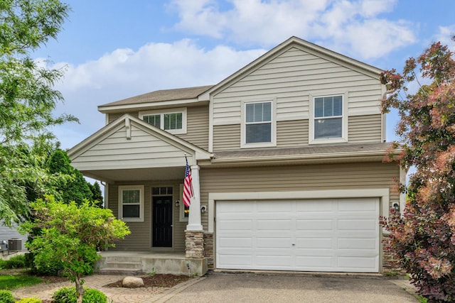6773 Urbandale Ln N, Maple Grove, MN 55311 - view of front of house with a garage, asphalt driveway, and covered porch