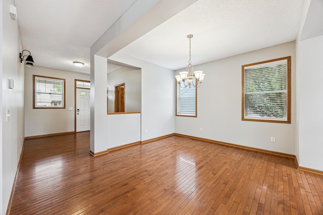 6773 Urbandale Ln N, Maple Grove, MN 55311 - unfurnished room featuring hardwood / wood-style floors and a chandelier