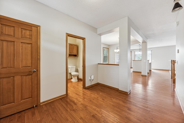 6773 Urbandale Ln N, Maple Grove, MN 55311 - hall featuring hardwood / wood-style floors and a chandelier