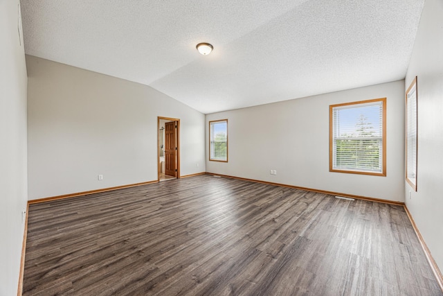 6773 Urbandale Ln N, Maple Grove, MN 55311 - empty room with dark wood finished floors, vaulted ceiling, and a textured ceiling