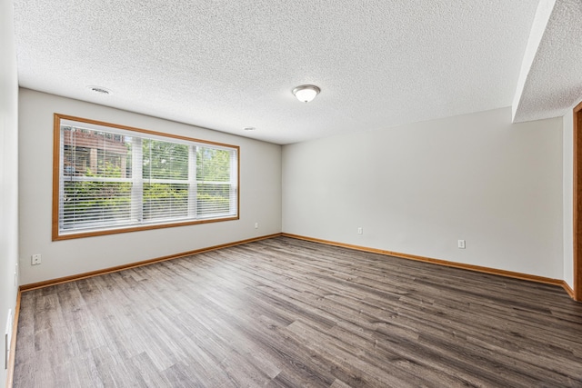 6773 Urbandale Ln N, Maple Grove, MN 55311 - spare room featuring wood finished floors and a textured ceiling