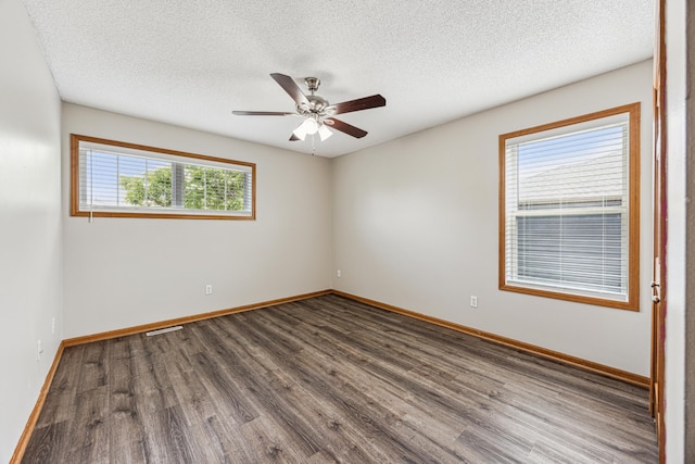 6773 Urbandale Ln N, Maple Grove, MN 55311 - unfurnished room with dark wood finished floors, ceiling fan, and a textured ceiling