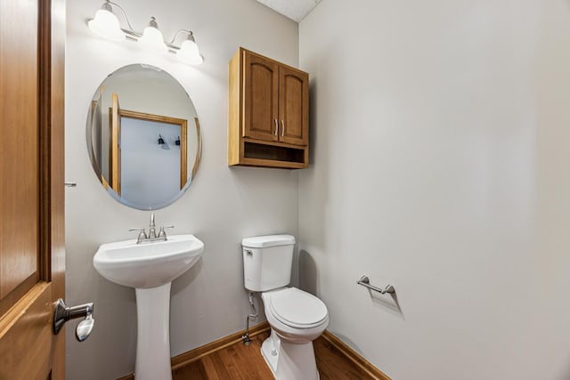 6773 Urbandale Ln N, Maple Grove, MN 55311 - half bath featuring wood finished floors and toilet