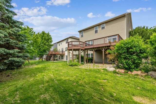6773 Urbandale Ln N, Maple Grove, MN 55311 - rear view of house featuring a deck and a yard