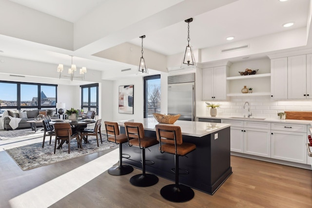 222 Ferndale Rd S, Wayzata, MN 55391 - kitchen featuring stainless steel built in fridge, open shelves, wood finished floors, a kitchen island, and recessed lighting