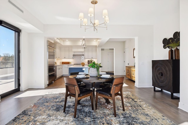 222 Ferndale Rd S, Wayzata, MN 55391 - dining area with a chandelier, wood finished floors, and a raised ceiling