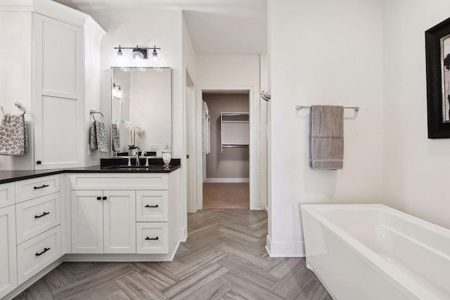 222 Ferndale Rd S, Wayzata, MN 55391 - bathroom featuring a walk in closet, a bathtub, and vanity