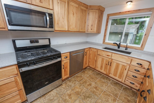 17 Lake St, Osakis, MN 56360 - kitchen featuring stainless steel appliances, decorative backsplash, light stone finish flooring, and light brown cabinets
