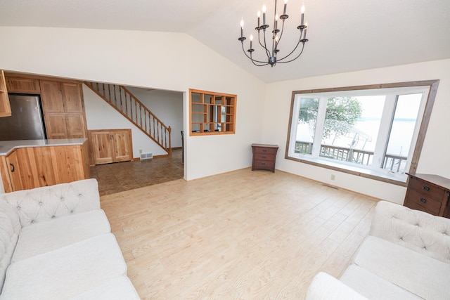 17 Lake St, Osakis, MN 56360 - living room with a chandelier, light wood finished floors, lofted ceiling, and stairs