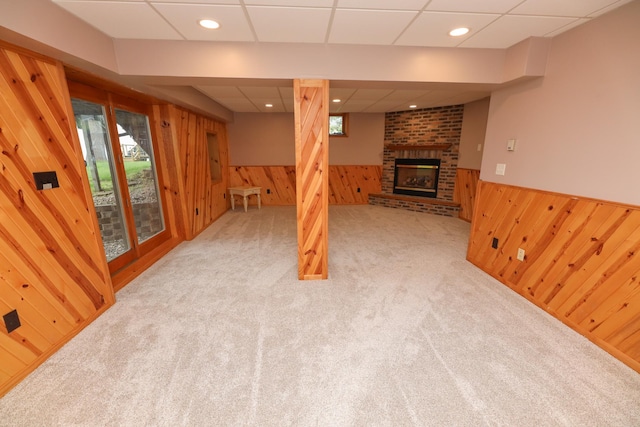 17 Lake St, Osakis, MN 56360 - unfurnished living room with wooden walls, a wainscoted wall, carpet, and a fireplace