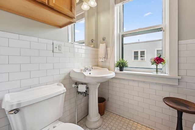 1725 Hague Ave Unit 4, Saint Paul, MN 55104 - bathroom with tile walls, plenty of natural light, and wainscoting